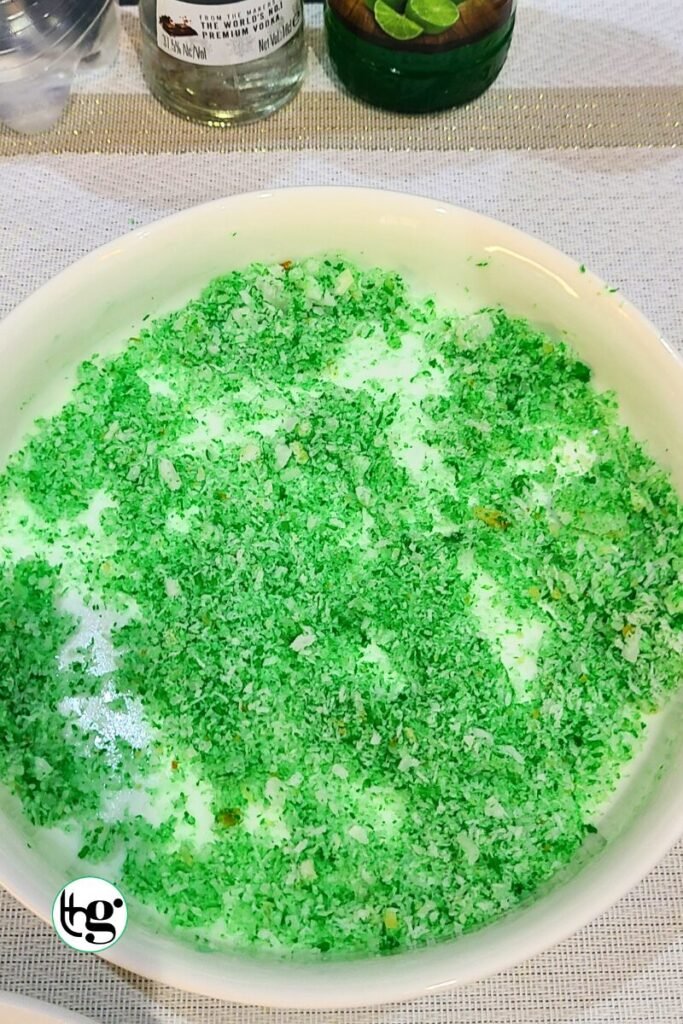 Dessicated cocont and food colour mixture for spooky green halloween shots