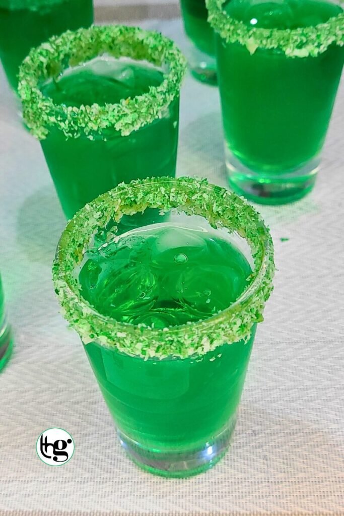 Spooky green halloween cocktail poured into prepared glass