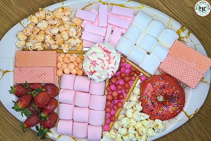 Valentine’s dessert board with cupcakes and pink doughnuts
