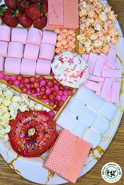 Valentine’s Sweet Treats Board with candy and strawberries